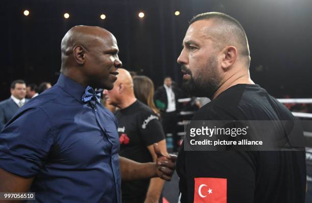 Boxing legend Chris Eubank and coach Ahmet Oner stand across from one another at the Super middleweight match between Eubank Jr. Of Great Britain and...