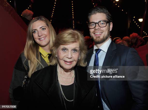 Gundel Fuchsberger, widow of moderator Joachim Fuchsberger, her grandson Julien Maximilian and his wife Natalie Weber smile and pose during the...