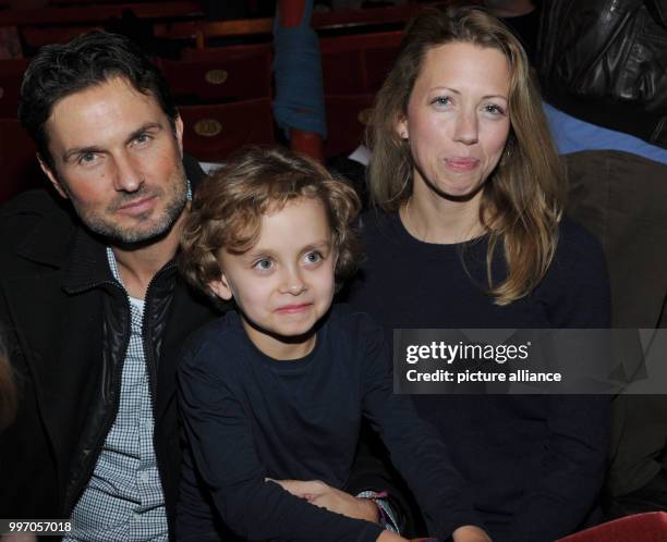 Director Simon Verhoeven, his partner Nina and their son David smile and pose during the premiere gala of Circus Roncalli under the slogan "40 years...