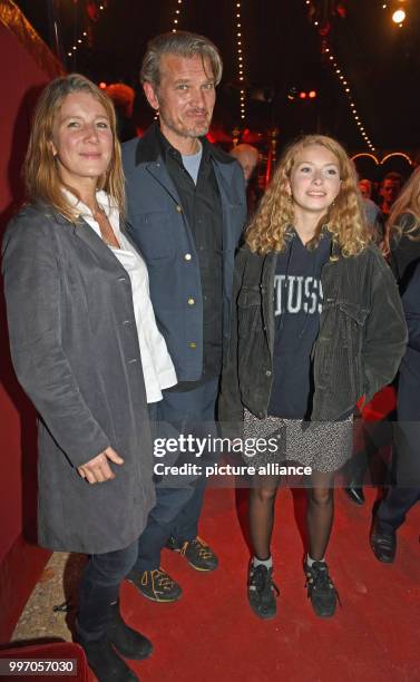 Actor Goetz Otto, his wife Sabine and daughter Luna smile and pose during the premiere gala of Circus Roncalli under the slogan "40 years of...