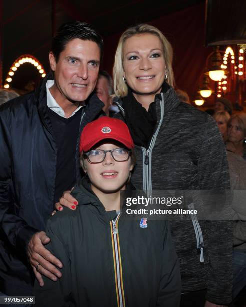 The former ski athlete Maria Hoefl-Riesch, her husband Marcus Hoefl and his son Luca smile and pose during the premiere gala of Circus Roncalli under...