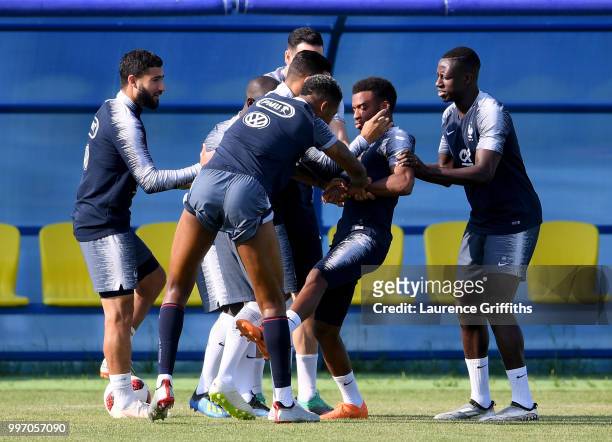 Nabil Fekir, Thomas Lemar, Presnel Kimpembe and Blaise Matuidi of France joke during a France trainig session on July 12, 2018 in Moscow, Russia.