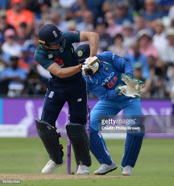 Jos Buttler of England is caught by MS Dhoni of India during the 1st Royal London One-Day International between England and India on July 12, 2018 in...