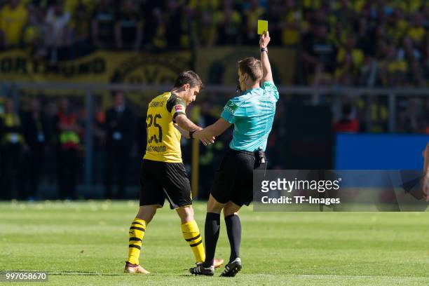 The referee shows a yellow card to Sokratis of Dortmund during the Bundesliga match between Borussia Dortmund and 1. FSV Mainz 05 at Signal Iduna...