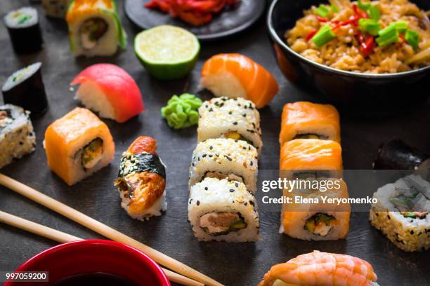 table served with sushi and traditional japanese food - wakame stock-fotos und bilder