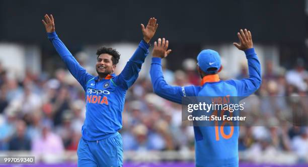 India bowler Kuldeep Yadav celebrates with captain Virat Kohli after Yadav had dismissed David Willey during the 1st Royal London One Day...