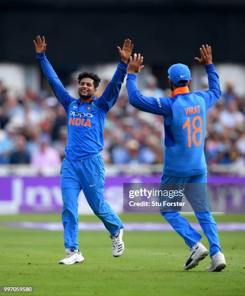 India bowler Kuldeep Yadav celebrates with captain Virat Kohli after Yadav had dismissed David Willey during the 1st Royal London One Day...