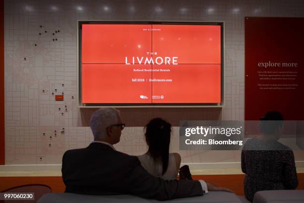 People sit in the sales center for the GWL Realty Advisors Livmore luxury apartment building in Toronto, Ontario, Canada, on Tuesday, July 10, 2018....