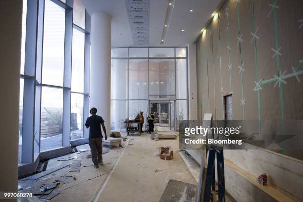Workers stand in the lobby during construction of the GWL Realty Advisors Livmore luxury apartment building in Toronto, Ontario, Canada, on Tuesday,...