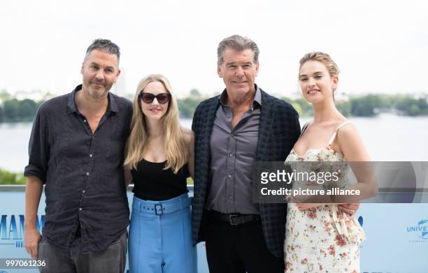 July 2018, Germany, Hamburg: American actress Amanda Seyfried , British actress Lily James and Irish actor Pierce Brosnan and the director Ol Parker...