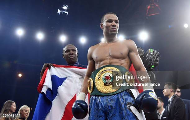 Britain's Chris Eubank Jr. And his coach and father Chris Eubank stand together after their victory during the World Boxing Super Series IBO...