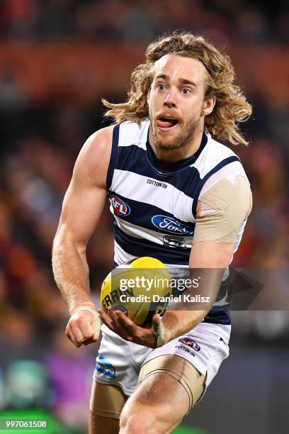 Cameron Guthrie of the Cats handballs during the round 17 AFL match between the Adelaide Crows and the Geelong Cats at Adelaide Oval on July 12, 2018...