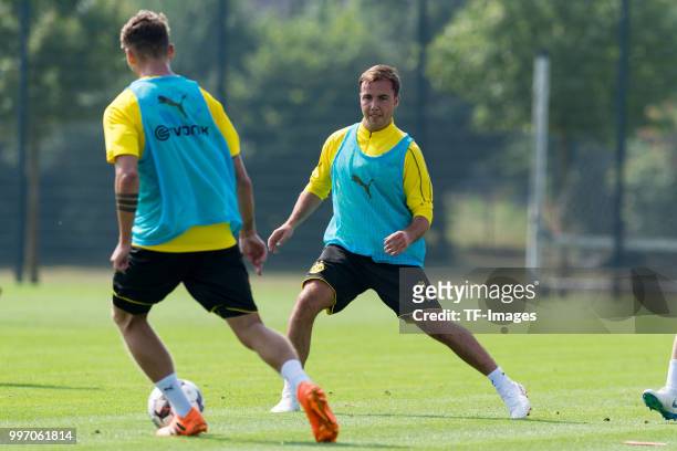 Maximilian Philipp of Dortmund and Mario Goetze of Dortmund battle for the ball during a training session at BVB training center on July 12, 2018 in...