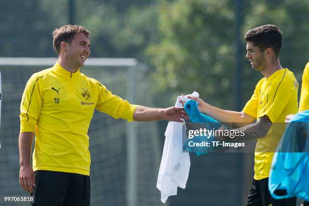 Mario Goetze of Dortmund laughs and Christian Pulisic of Dortmund looks on during a training session at BVB training center on July 12, 2018 in...