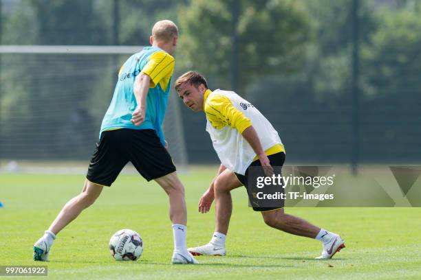 Sebastian Rode of Dortmund and Mario Goetze of Dortmund battle for the ball during a training session at BVB training center on July 12, 2018 in...