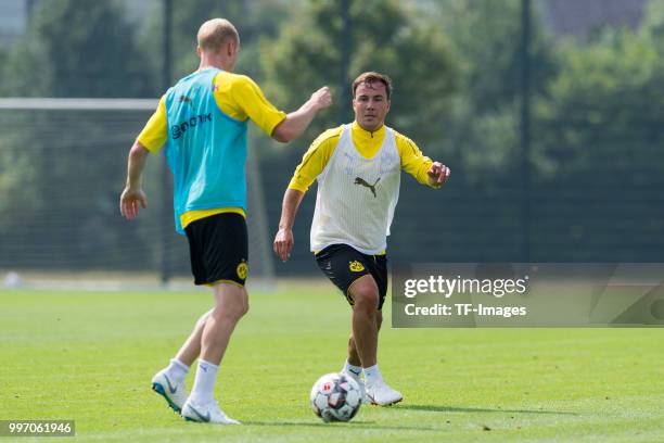 Sebastian Rode of Dortmund and Mario Goetze of Dortmund battle for the ball during a training session at BVB training center on July 12, 2018 in...