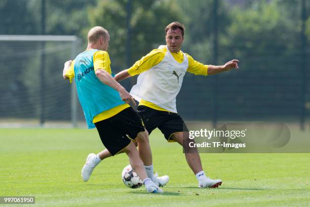 Sebastian Rode of Dortmund and Mario Goetze of Dortmund battle for the ball during a training session at BVB training center on July 12, 2018 in...