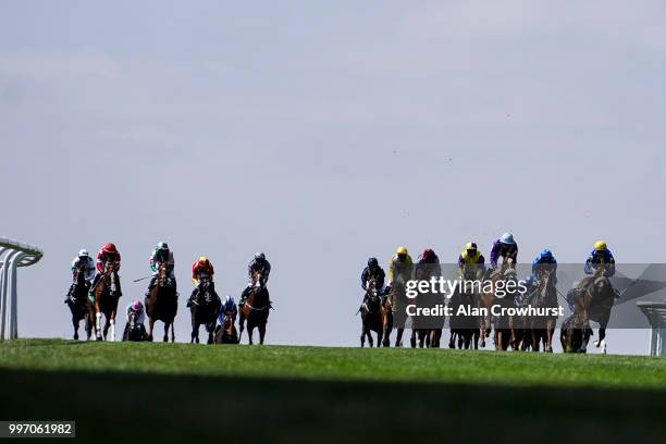 General view as runners ease down after finishing at Newmarket Racecourse on July 12, 2018 in Newmarket, United Kingdom.