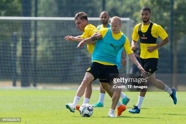 Maximilian Philipp of Dortmund and Sebastian Rode of Dortmund battle for the ball during a training session at BVB training center on July 12, 2018...