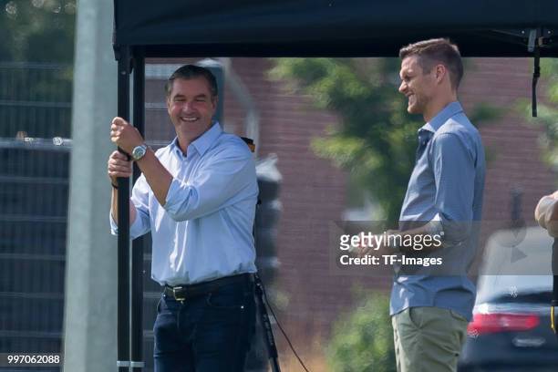 Sporting director Michael Zorc of Dortmund and Head of the Licensing Player Department Sebastian Kehl of Dortmund laugh during a training session at...
