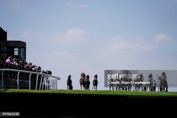 General view as runners ease down after finishing at Newmarket Racecourse on July 12, 2018 in Newmarket, United Kingdom.