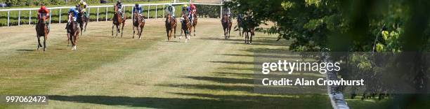 General view as runners ease down after finishing at Newmarket Racecourse on July 12, 2018 in Newmarket, United Kingdom.