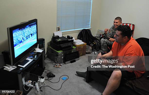Army Specialist Zachari Klawonn, left, plays video games with his new roommate, Arnold Mendez, on March 17 in Killeen, TX. Army officials suggested...