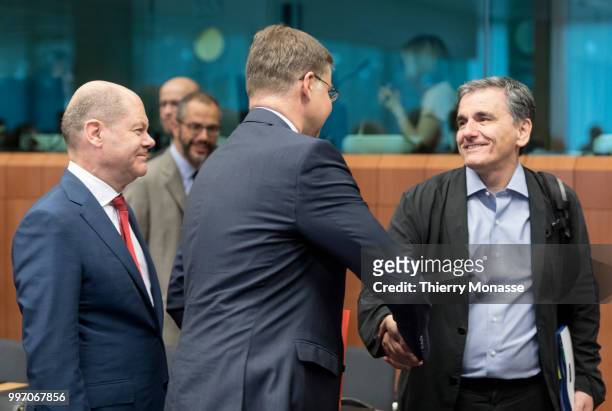 German Federal Minister of Finance Olaf Scholz is talking with the EU Euro & Social Dialogue Commissioner Valdis Dombrovskis and the Greek Finance...