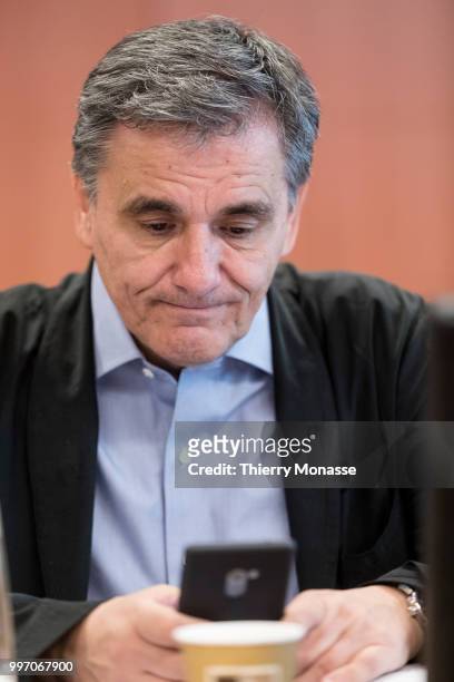 Greek Finance Minister Euclid Tsakalotos is looking at his smartphone prior an Eurogroup Ministers meeting on july 12 in the Justus Lipsius, the EU...