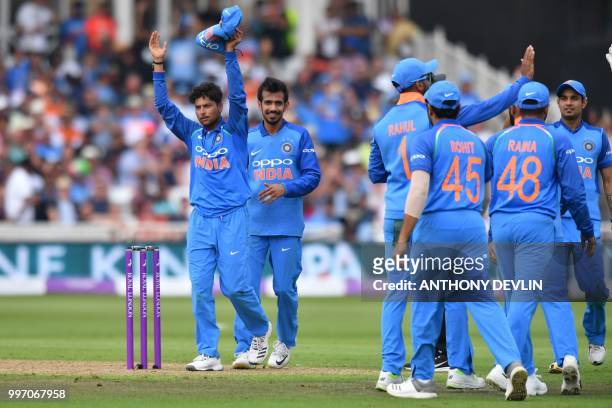India's Kuldeep Yadav celebrates after finishing his spell, taking his sixth wicket, that of England's David Willey during the One Day International...