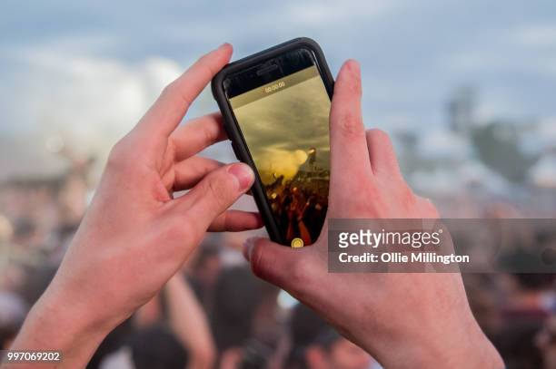 Music fan video's Tory Lanez with an iPhone as he performs while crowd surfing at the mainstage at The Plains of Abraham in The Battlefields Park...