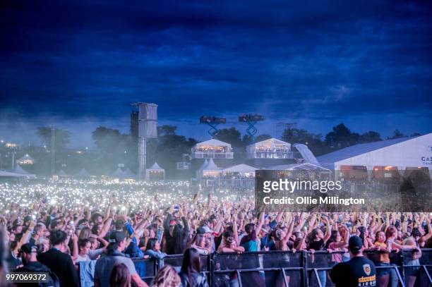 The crowd watch on with mobile phone lights as Tory Lanez performs onstage at the mainstage at The Plains of Abraham in The Battlefields Park during...