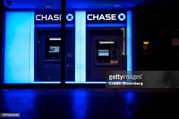 JPMorgan Chase & Co. Signage is illuminated at night above automatic teller machines in Chicago, Illinois, U.S., on Tuesday, July 10, 2017. JPMorgan...