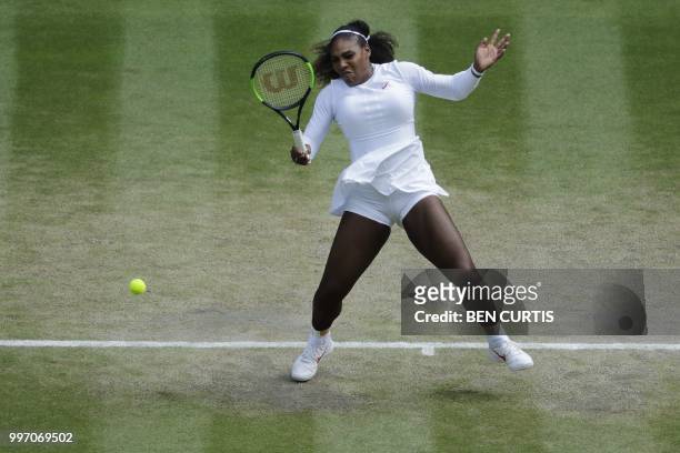 Player Serena Williams returns against Germany's Julia Goerges during their women's singles semi-final match on the tenth day of the 2018 Wimbledon...