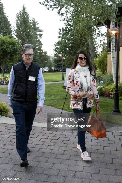 John Henry, businessman and owner of the Boston Red Sox, walks with his wife Linda Henry as they attend the annual Allen & Company Sun Valley...