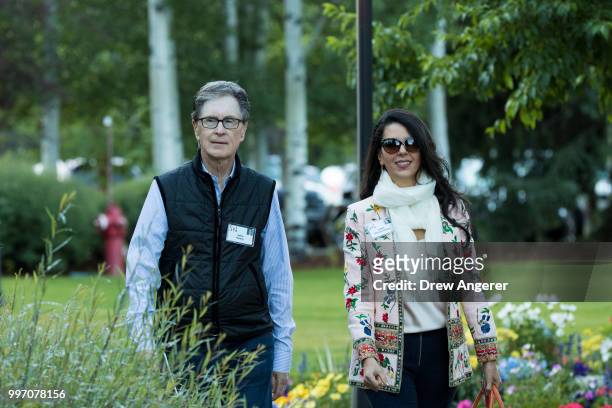 John Henry, businessman and owner of the Boston Red Sox, walks with his wife Linda Henry as they attend the annual Allen & Company Sun Valley...