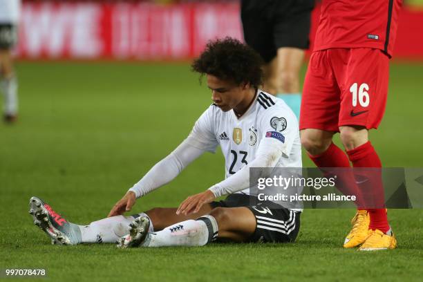 Germany's Leroy Sane sitting on the pitch during the World Cup Group C soccer qualifier match between Germany and Azerbaijan at the Fritz Walter...