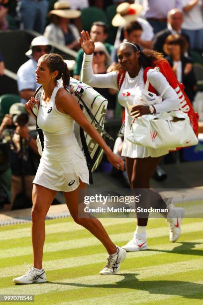 Julia Goerges of Germany and Serena Williams of The United States leave the court after their Ladies' Singles semi-final match on day ten of the...