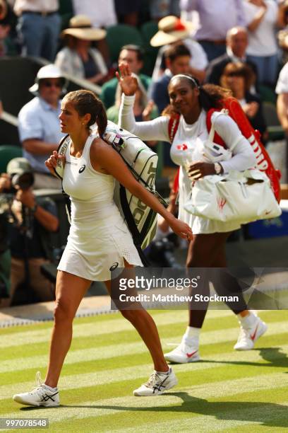 Julia Goerges of Germany and Serena Williams of The United States leave the court after their Ladies' Singles semi-final match on day ten of the...