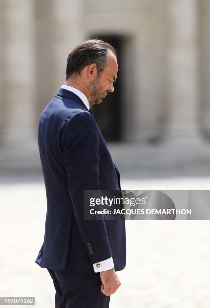 French Prime minister Edouard Philippe looks down as he takes part in a tribute ceremony to French filmmaker and writer Claude Lanzmann on July 12 at...