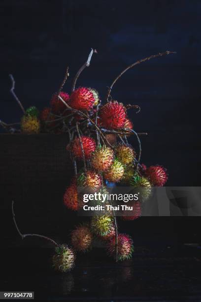 a basket of rambutans. - rambutan stock pictures, royalty-free photos & images