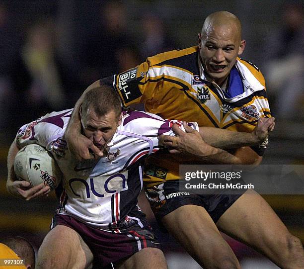 Phil Bailey of the Eagles is tackled by Tyran Smith of the Tigers during the round 21 NRL match between the Wests Tigers and the Northern Eagles held...