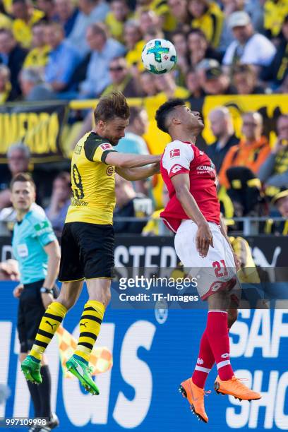 Marcel Schmelzer of Dortmund and Karim Onisiwo of Mainz battle for the ball during the Bundesliga match between Borussia Dortmund and 1. FSV Mainz 05...