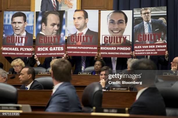 Posters of people who have plead guilty in special counsel Robert Mueller's probe into Russian interference in the U.S. Elections are held by staff...