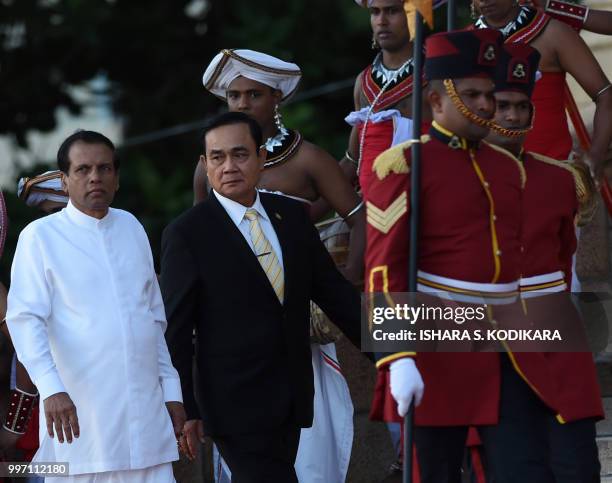 Thai Prime Minister Prayut Chan-O-Cha walks with Sri Lankan President Maithripala Sirisena during a welcoming ceremony at the Presidential...