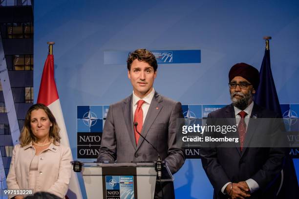 Justin Trudeau, Canada's prime minister, center, speaks flanked by Chrystia Freeland, Canada's minister of foreign affairs, left, and Harjit Sajjan,...
