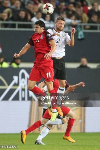 Germany's Shkodran Mustafi and Azerbaijan's Ramil Sheydaev vie for the ball during the World Cup Group C soccer qualifier match between Germany and...