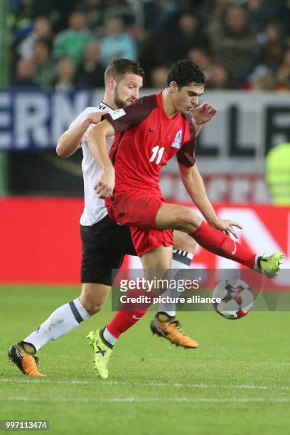 Germany's Shkodran Mustafi and Azerbaijan's Ramil Sheydaev vie for the ball during the World Cup Group C soccer qualifier match between Germany and...