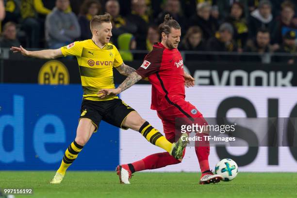 Marco Reus of Dortmund and Marco Russ of Frankfurt battle for the ball during the Bundesliga match between Borussia Dortmund and Eintracht Frankfurt...
