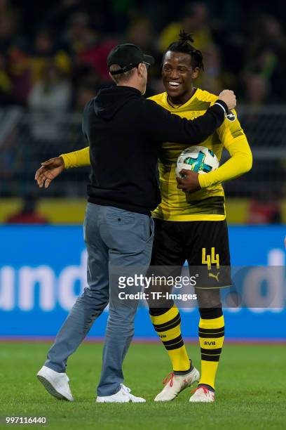 Head coach Peter Stoeger of Dortmund and Michy Batshuayi of Dortmund celebrate after winning the Bundesliga match between Borussia Dortmund and...
